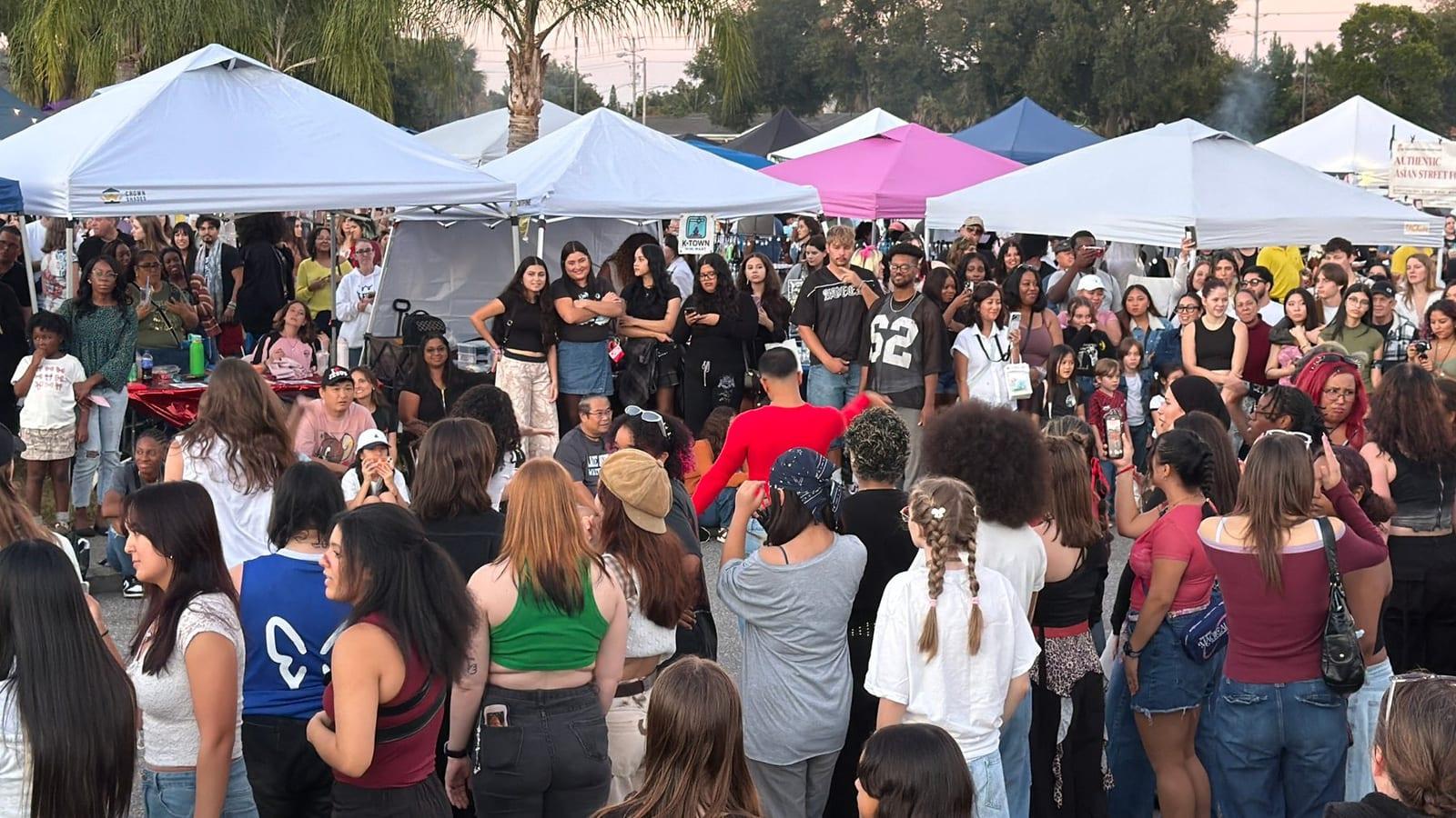 The crowd forming a circle for Random Dance Play under the tents