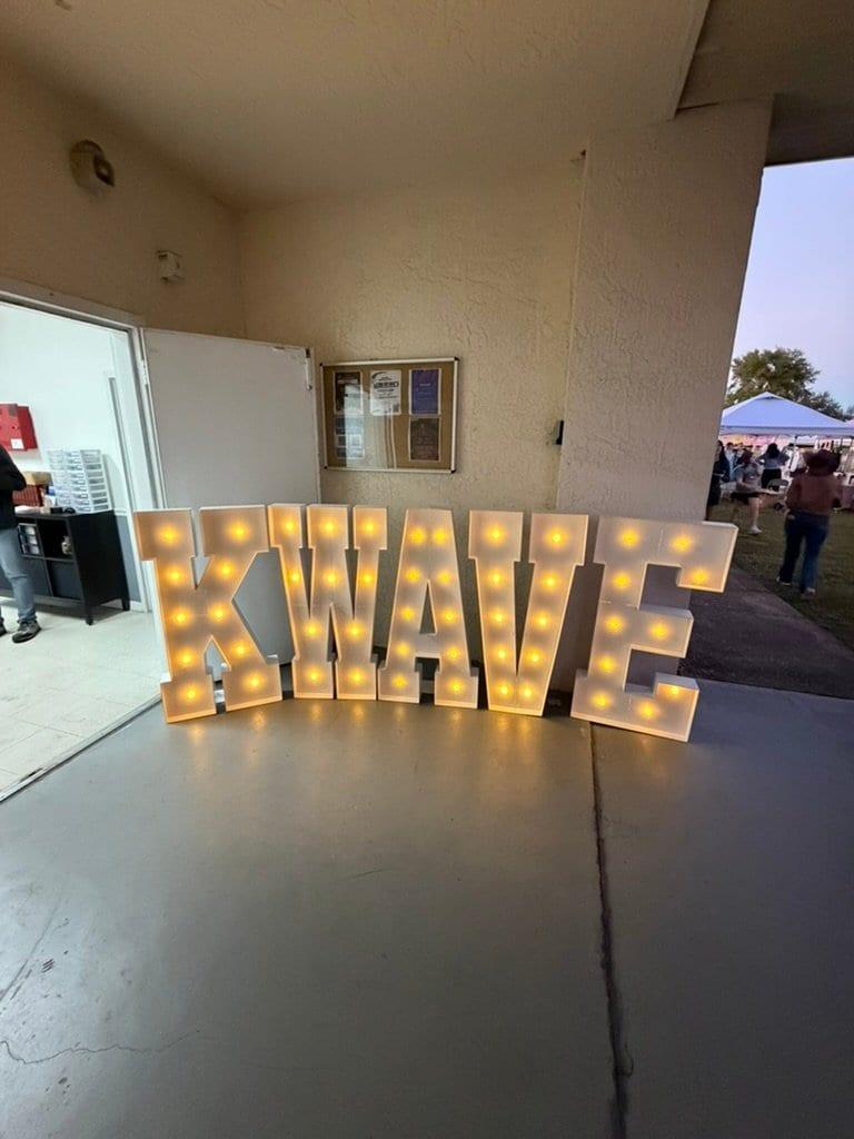 The lit-up K-WAVE marquee letters